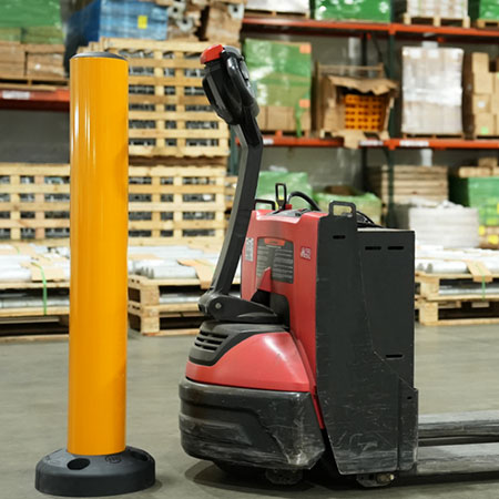 yellow bollard next to walkie pallet truck